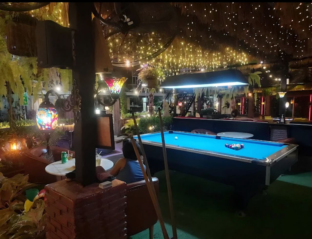 Pool table and lounge seating under string lights at Q Garden Pattaya