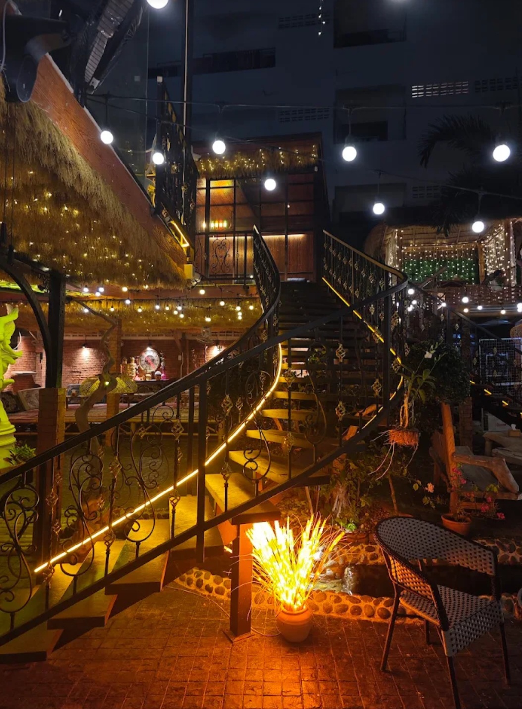 Illuminated curved stairway with golden lights at Q Garden Pattaya