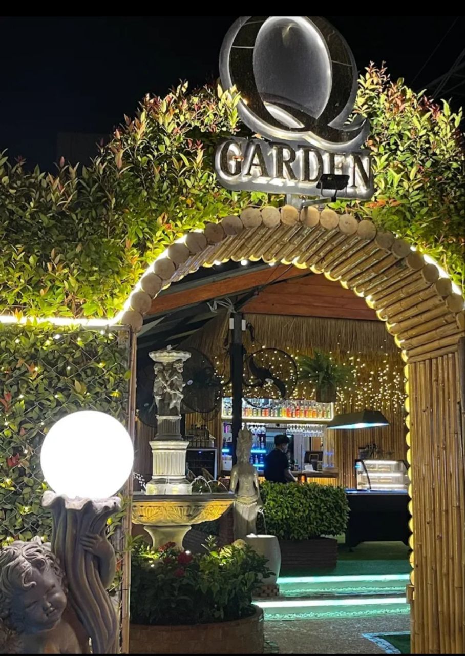 Q Garden entrance with illuminated bamboo arch and Q Garden sign